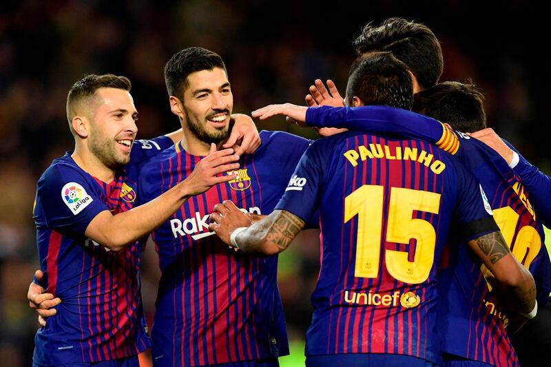 Barcelona's Brazilian midfielder Paulinho (2R) celebrates with Barcelona's Uruguayan forward Luis Suarez, Barcelona's Spanish defender Jordi Alba and other teammates after scoring during the Spanish league football match FC Barcelona against RC Deportivo de la Coruna at the Camp Nou stadium in Barcelona on December 17, 2017. / AFP PHOTO / JAVIER SORIANO