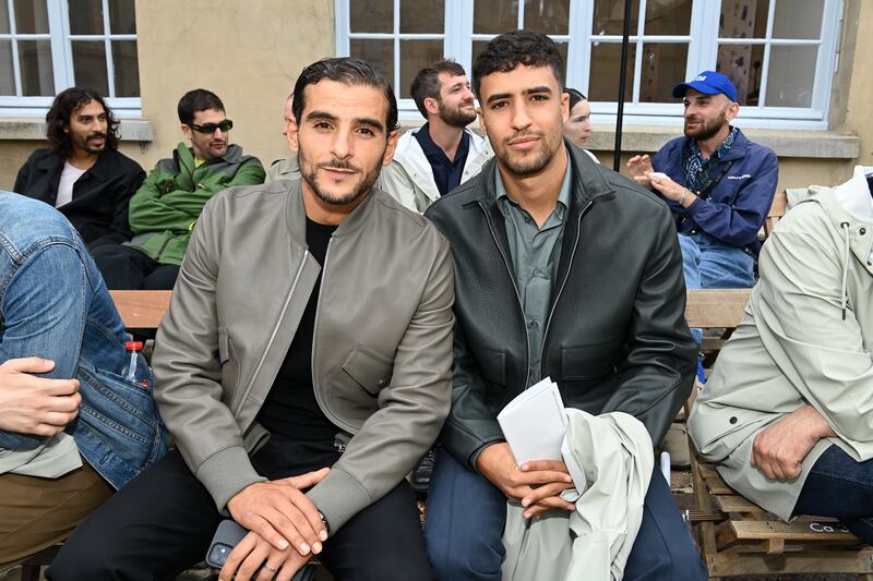 French-Algerian rapper Sofiane Zermani and actor Shain Boumedine attend the Hermes menswear spring/summer 2023 show as part of Paris Fashion Week, on June 25, 2022. Getty Images