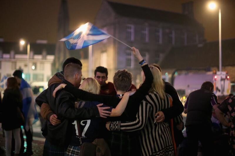 Yes vote campaigners console themselves outside the Scottish Parliament building. Christopher Furlong / Getty Images
