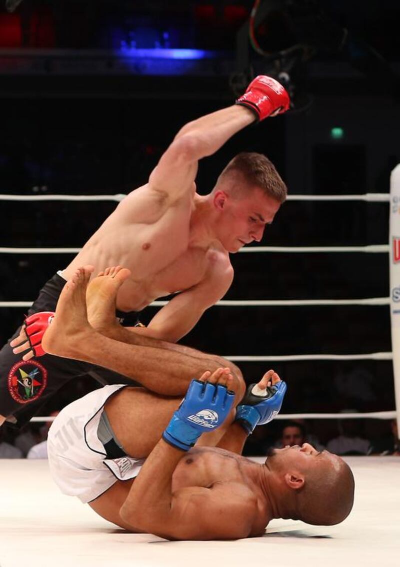 The UAE’s Ahmad Al Darmaki, in white shorts, fights with Artiyom Gorodynets from Ukraine in the Abu Dhabi Warriors 4 at IPIC Arena in Zayed Sports city in Abu Dhabi. Ravindranath K / The National