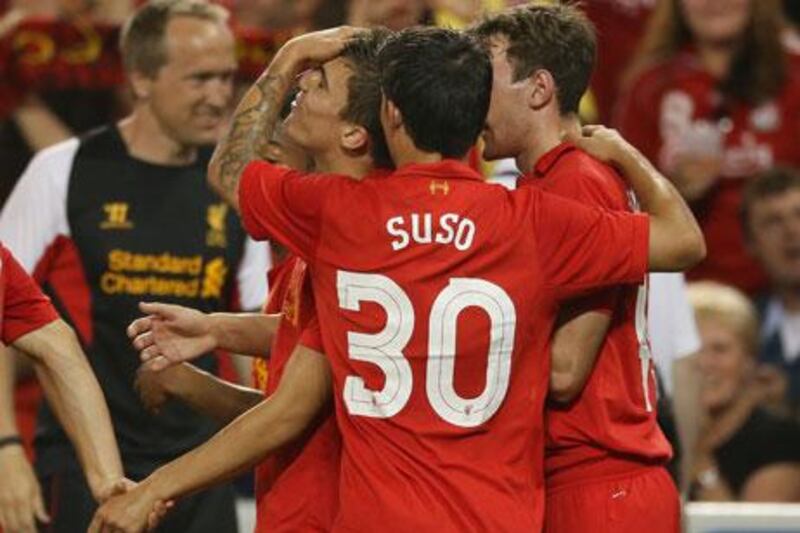 Adam Morgan is congratulated by Liverpool teammates Suso and Jack Robinson after scoring against Toronto