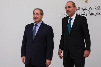 Jordan's Foreign Minister Ayman Safadi, right, met his Syrian counterpart Faisal Mekdad at a regional consultative meeting held in Amman on May 1. AP
