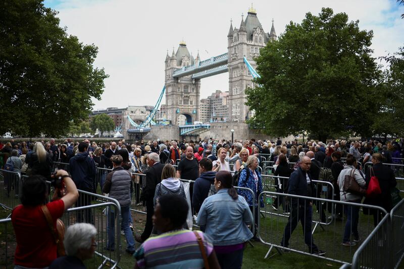 People wait in a queue near Tower Bridge in London to pay their respects to Queen Elizabeth II. Reuters