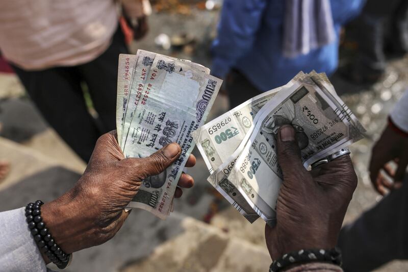 A man counts Indian rupee banknotes in an arranged photograph in Varanasi, Uttar Pradesh, India, on Saturday, Oct. 29, 2017. A big drop in borrowing costs for Indian state lenders on perpetual bond offerings shows that the government’s surprise $32 billion capital pledge last week has finally managed to turn around market sentiment. Photographer: Dhiraj Singh/Bloomberg