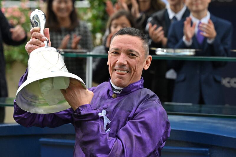 Italian jockey Frankie Dettori poses with his trophy at the presentation ceremony after his victory on King of Steel in the Champion Stakes. AFP
