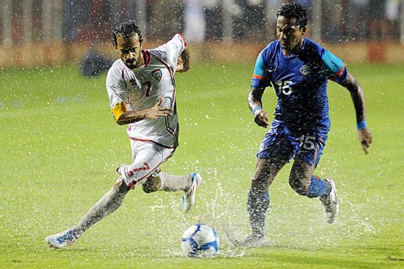 Ali Al Wehaibi, the UAE captain, left, goes for the ball during soggy conditions in Delhi...

Arshad Abu Bakr / UAEFA