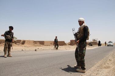 Afghan security officials patrol on Helmand-Kandahar highway, in Helmand, Afghanistan, 11 August 2020. EPA