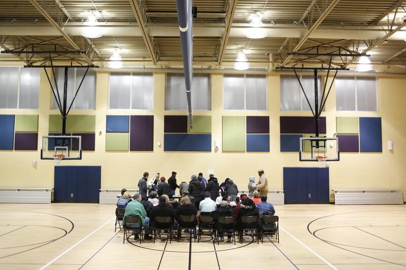 Democrats get checked in for a caucus at Highland Elementary on February 1, in Waterloo, Iowa. Matthew Putney / The Courier via AP