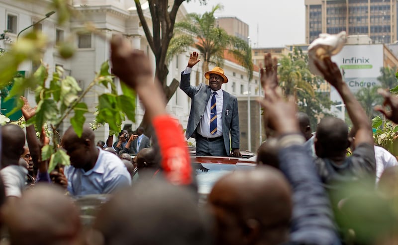 Opposition leader Raila Odinga smiles and waves to a crowd of his supporters as he leaves the Supreme Court in downtown Nairobi, Kenya Friday, Sept. 1, 2017. Kenya's Supreme Court on Friday nullified President Uhuru Kenyatta's election win last month and called for new elections within 60 days, shocking a country that had been braced for further protests by opposition supporters. (AP Photo/Ben Curtis)