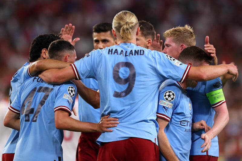 12) Haaland celebrates with teammates after scoring his second and City's third against Sevilla. Getty