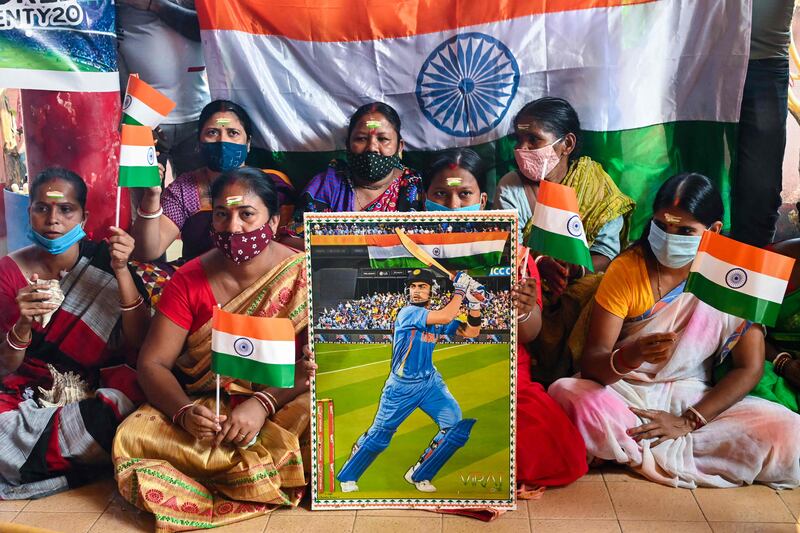 Cricket fans in Kolkata hold a placard with the picture of India's captain Virat Kohli. AFP