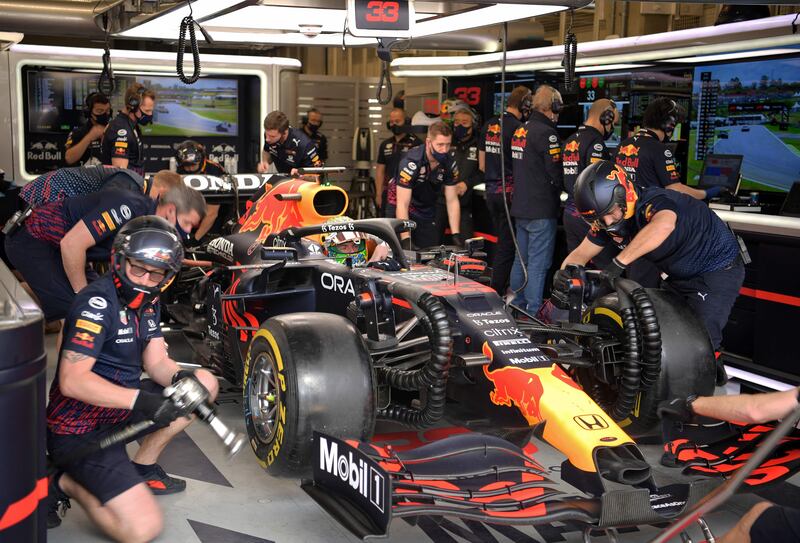 Red Bull's Max Verstappen sits in his car at the team's garage in pit lane at Interlagos racetrack. AFP