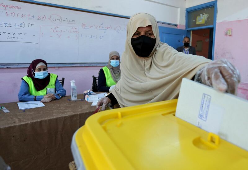 A woman casts her ballot as Jordanians began voting in a parliamentary election overshadowed by the coronavirus pandemic. AP