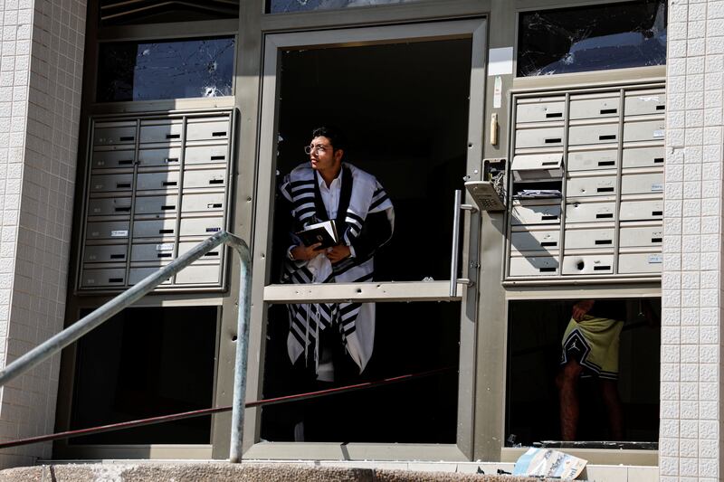 A man looks out from a damaged building in Ashkelon, southern Israel, after rockets were launched from the Gaza Strip. Reuters