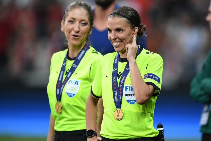 Stephanie Frappart smiles next to assistant referee Manuela Nicolosi. AFP