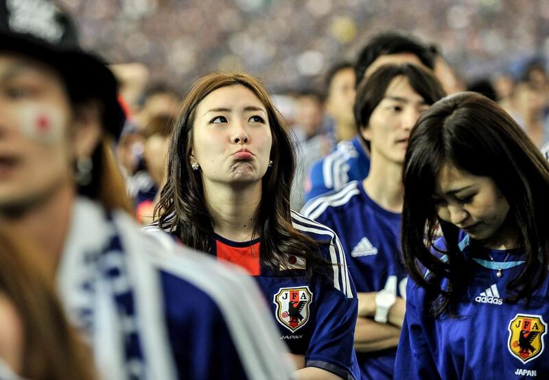 Japanese fans react after Japan is defeated by Ivory Coast at a public viewing in Tokyo at the Tokyo Dome on Sunday. Keith Tsuji / Getty Images