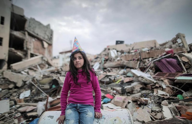A Palestinian child amid the rubble in Gaza. Belal Khaled
