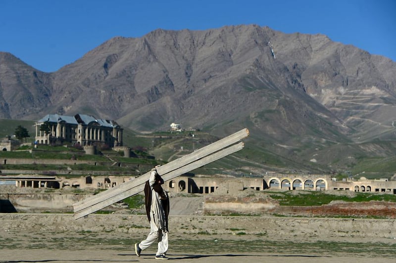 Afghan labourer Afzal Khan, 22, carries wood on his shoulder on April 19. Afghanistan's economy is recovering from decades of conflict but despite the significant improvement in the last decade it is extremely poor, and highly dependent on foreign aid. AFP