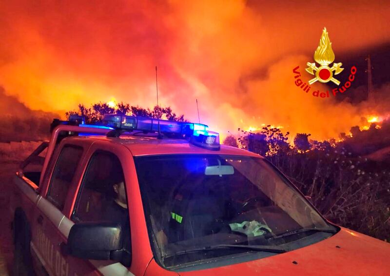 Fire turns the sky a vivid orange near Mandas, southern Sardinia. AP