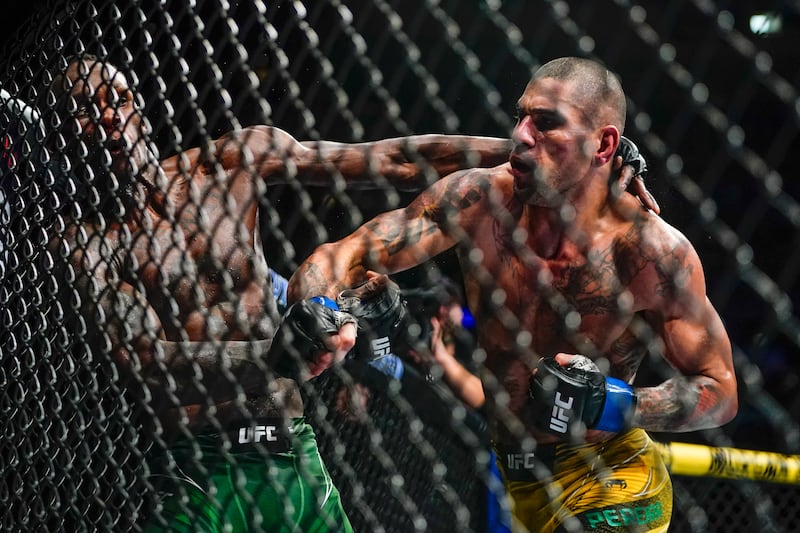 Alex Pereira punches Israel Adesanya during the fifth round of their middleweight title bout. AP