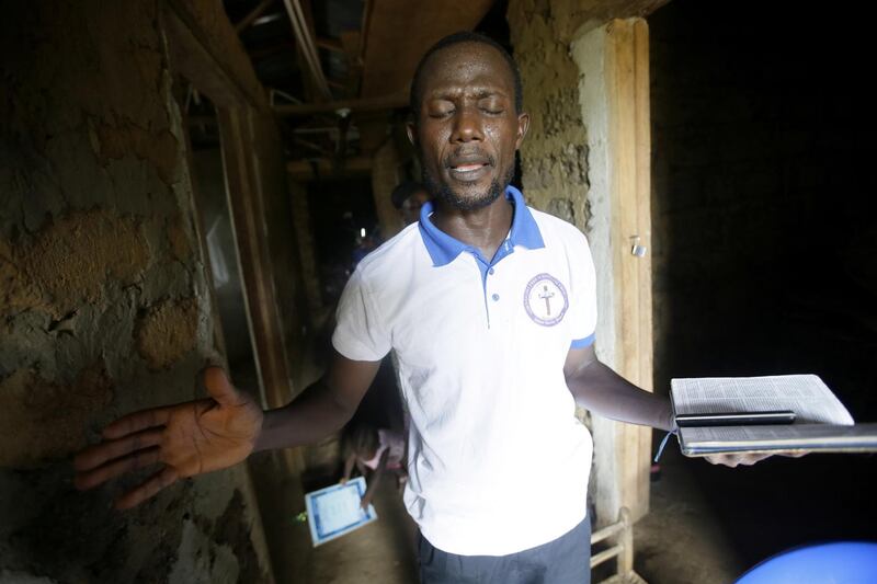 Pastor Abednego T.  Kendema offer prayers during a service at his home at Mount Barclay community, a suburb of Monrovia, Liberia. According to reports, the government of Liberia has closed down schools and the major churches have suspended services after the first two cases of COVID-19 were announced in the country. The government ordered the compulsory wearing of face masks and has extended the Stay Home order by two weeks, and proposed to reopen mosques and churches, on 17 May 2020 with restrictions.  EPA