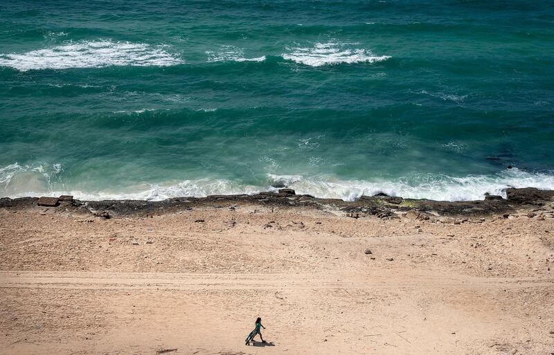 A girl walks by a close public beach, amid the ongoing coronavirus COVID-19 pandemic, in the northern coast near Alexandria, Egypt .  EPA