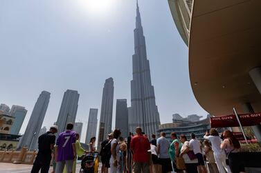 Tourists gather to look at the Burj Khalifa in Dubai. Chris Whiteoak / The National