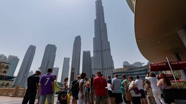 Tourists gather to look at the Burj Khalifa in Dubai. Chris Whiteoak / The National