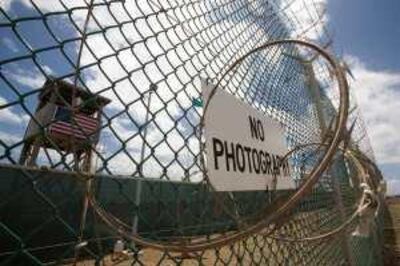 The outer fence and guard tower at Camps 1 & 4 at Camp Delta at the US Naval Station in Guantanamo Bay, Cuba, 24 April 2007 mans his security station. US Militrary officials list about 385 current detainees of various threat levels and nationalities being held on the US base in Cuba captured in the US war on terror. AFP Photo/Paul J. Richards