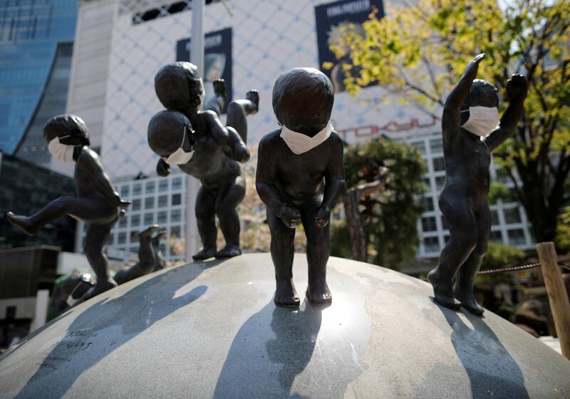 Statues wearing protective face masks are seen at the Shibuya shopping and entertainment district in Tokyo, Japan. REUTERS