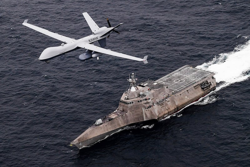 In this handout image from the US Navy, an MQ-9 Sea Guardian unmanned maritime surveillance drone flies over the 'USS Coronado' in the Pacific Ocean. AP