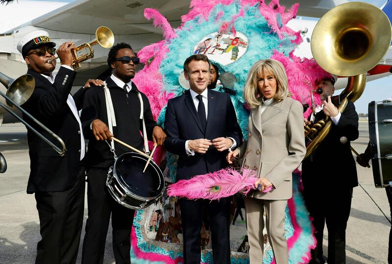 Mr Macron and his wife are serenaded on the tarmac by the Crescent City All Stars. AFP