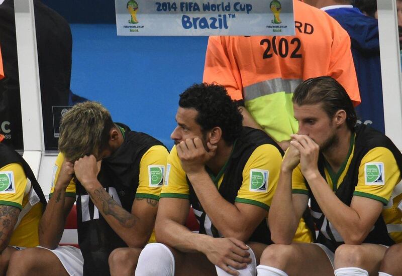 Neymar, left, covers his face as he sits next to Fred and Henrique on the bench during Brazil's third-place match loss on Saturday against the Netherlands at the 2014 World Cup in Brasilia, Brazil. Fabrice Coffrini / AFP / July 12, 2014