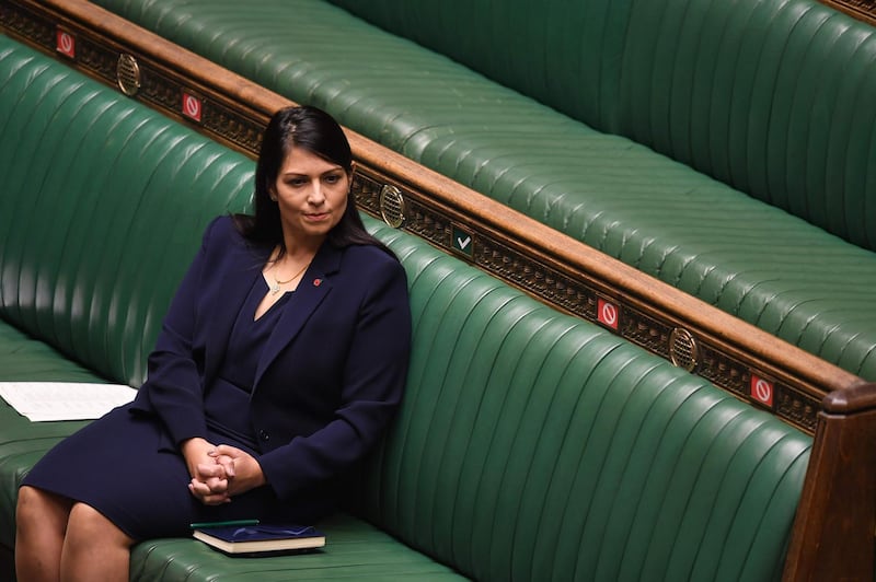 A handout photograph released by the UK Parliament shows Britain's Home Secretary Priti Patel listening as Britain's Prime Minister Boris Johnson speaks in the House of Commons in London on November 2, 2020 on new coronavirus lockdown measures. British Prime Minister Boris Johnson on Monday defended his belated decision to impose a second coronavirus lockdown as critics claimed he could have saved "thousands" of lives by acting sooner. After persisting for weeks with local and regional restrictions, Johnson announced at the weekend that a new nationwide lockdown would come into force from Thursday and end on December 2, bringing England into line with other parts of the UK and Europe. - RESTRICTED TO EDITORIAL USE - MANDATORY CREDIT " AFP PHOTO / UK PARLIAMENT " - NO USE FOR ENTERTAINMENT, SATIRICAL, MARKETING OR ADVERTISING CAMPAIGNS - EDITORS NOTE THE IMAGE HAS BEEN DIGITALLY ALTERED AT SOURCE TO OBSCURE VISIBLE DOCUMENTS
 / AFP / UK PARLIAMENT / JESSICA TAYLOR / RESTRICTED TO EDITORIAL USE - MANDATORY CREDIT " AFP PHOTO / UK PARLIAMENT " - NO USE FOR ENTERTAINMENT, SATIRICAL, MARKETING OR ADVERTISING CAMPAIGNS - EDITORS NOTE THE IMAGE HAS BEEN DIGITALLY ALTERED AT SOURCE TO OBSCURE VISIBLE DOCUMENTS
