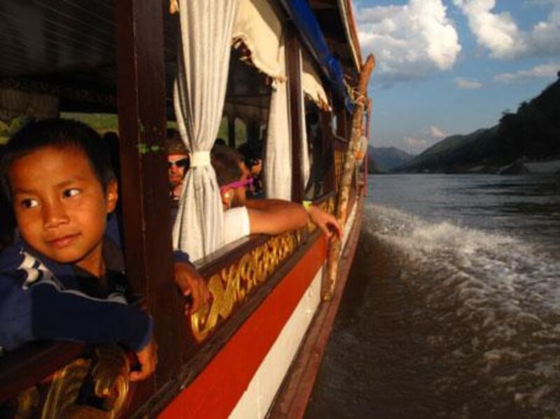 Locals and tourists alike are ferried down the Mekong River from Houayaxi to Luang Prabang, Laos, on houseboats.