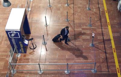 A passenger walks past empty check-in lines at Nice international airport. Eric Gaillard / Reuters