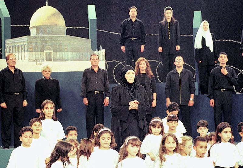 Egyptian veteran actress Huda Sultan (C) performs with Egyptian actors and singers (from L to R first row) Mahmud Yassin, Nadia Lutfi, Farouk al-Fishawi, Athar al-Hakim, Ahmad al-Saka, Khaled al-Nabawi and (from L to R 2nd row) Midhat Saleh, Anoshka and Mona Abdulghani a song dedicated to the al-Aqsa uprising is solidarity with the Palestinian people 20 October 2000. (Photo by AMR MAHMOUD / AFP)