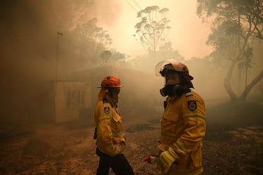 NSW Rural Fire Service and Fire and Rescue NSW crews work to protect a property on Kyola Road in Kulnura as the Three Mile fire approaches Mangrove Mountain, Australia, December 6, 2019. AAP Image/Dan Himbrechts/via REUTERS ATTENTION EDITORS - THIS IMAGE WAS PROVIDED BY A THIRD PARTY. NO RESALES. NO ARCHIVE. AUSTRALIA OUT. NEW ZEALAND OUT.
