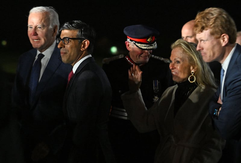 Mr Biden, Mr Sunak and Ms Hartley at the airport. AFP