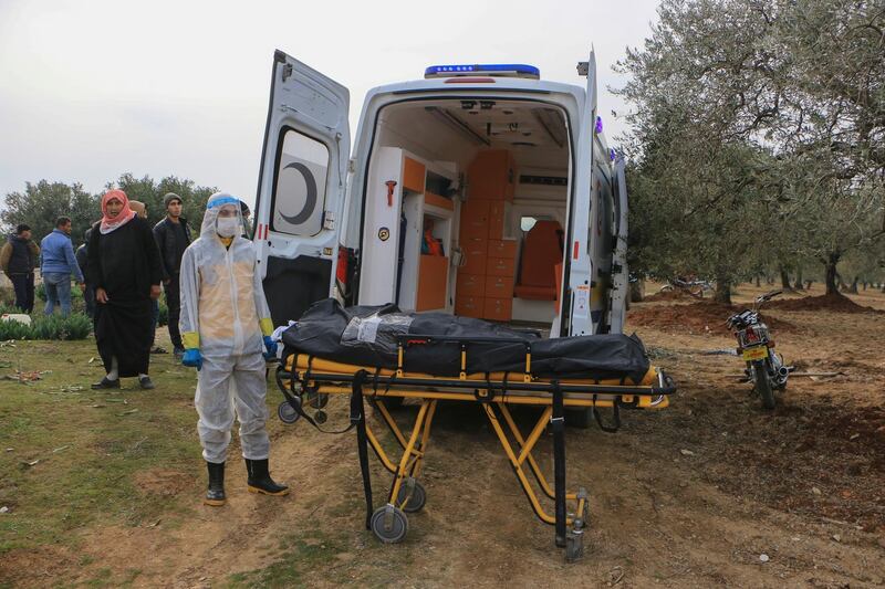 The ambulance arrives at the Salqeen cemetery in northwestern Syria. The body of a young woman who died from Covid-19 will be buried.