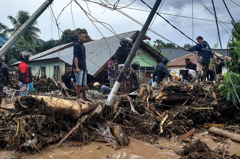 Residents pick through debris near damaged homes in Waiwerang village, East Flores, after torrential rains from Tropical Cyclone Seroja in Indonesia. AFP