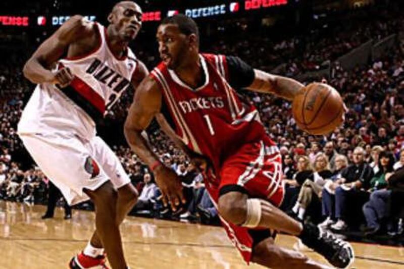 The Houston Rockets' Tracy McGrady, in red, went on a scoring spree during the Rockets' match with Phoenix Suns.