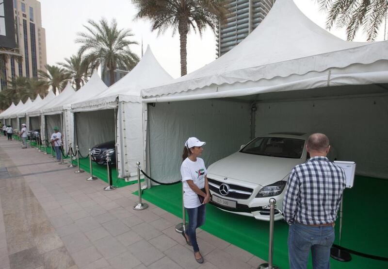 Car enthusiats visit the Dubai Green Auto Show at The Pavilion Downtown Dubai at Sheikh Mohammed bin Rashid Boulevard. Jaime Puebla / The National