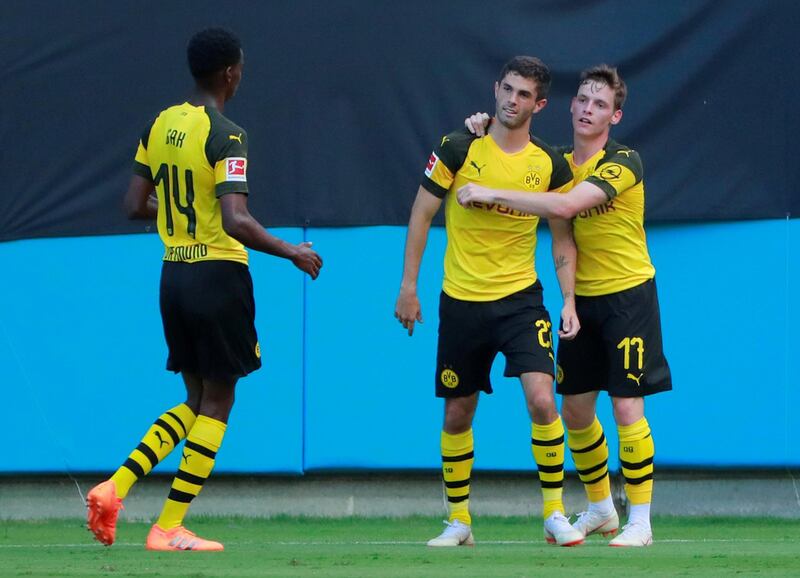 Borussia Dortmund's Christian Pulisic celebrates scoring a goal with team mates. Reuters