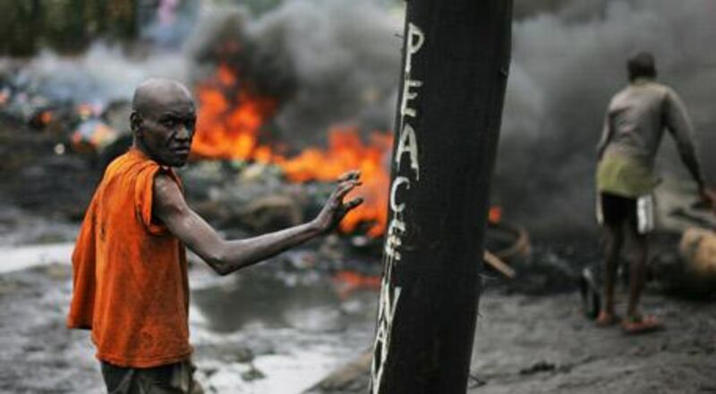 January, 2008: a police barricade in Nairobi's Kibera slum burns to the ground after being set on fire by supporters of Kenya's opposition leader, Raila Odinga.