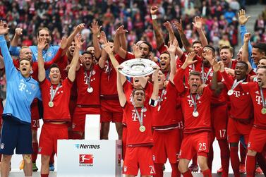 Bayern Munich captain Philipp Lahm lifts the Bundesliga trophy on May 23, 2015, nearly one month after Bayern had won the title. Getty Images