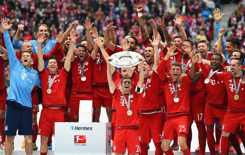MUNICH, GERMANY - MAY 23:  Captain Philipp Lahm of Bayern Muenchen lifts the Bundesliga trophy following the Bundesliga match between FC Bayern Muenchen and 1. FSV Mainz 05 at the Allianz Arena on May 23, 2015 in Munich, Germany.  (Photo by Lars Baron/Bongarts/Getty Images)