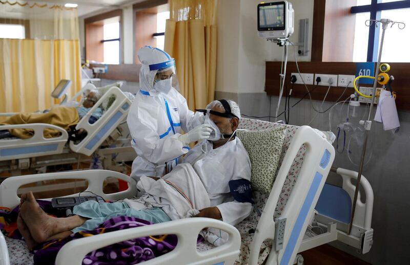 A medical worker takes care of a Covid-19 patient in the intensive care unit of the Yatharth Hospital in Noida, on the outskirts of New Delhi. Reuters