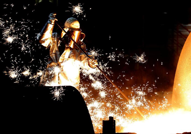 FILE PHOTO: A worker controls a tapping of a blast furnace at Europe's largest steel factory of Germany's industrial conglomerate ThyssenKrupp AG in the western German city of Duisburg December 6, 2012. REUTERS/Ina Fassbender/File Photo GLOBAL BUSINESS WEEK AHEAD