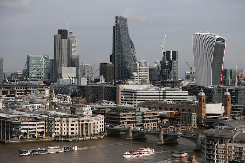 (FILES) This file photo taken on October 27, 2016 shows boats cruising along the Thames as the City of London's skyline is seen from the Tate Modern museum in London.
In a bid to expose the murky Nigerian money lurking behind some of London's most high-end properties, anti-corruption campaigners are offering an unusual property tour of the British capital, October 6, 2017. / AFP PHOTO / Daniel LEAL-OLIVAS